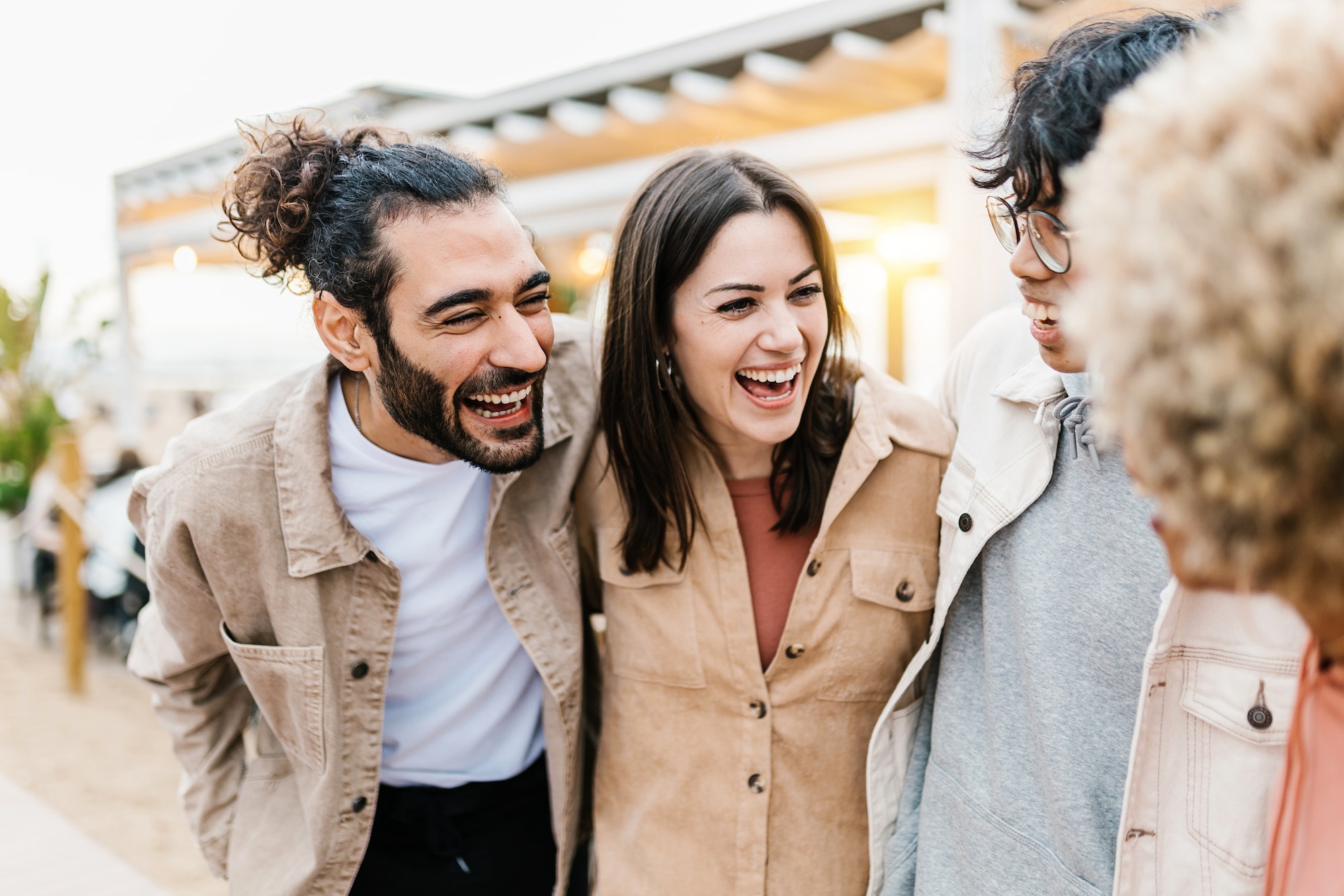 Group of young diverse friends having fun on party at beach